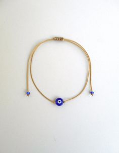 Evil eye bracelet Beige string Evil eye jewelry Evil eye women Evil eye men Greek evil eye Protection amulet Evil eye talisman Evil eye gift This simple yet beautifull bracelet is made using durable beige waxed string and has a glass beed evil eye charm in the middle,and blue seed beads at the ends. It is adjustable with a sliding knot closure. Other charm bracelets in my shop: https://www.etsy.com/shop/LuckyRatJewellery?section_id=16685466&ref=shopsection_leftnav_3 Other evil eye bracelets from Adjustable Evil Eye Bracelets For Meditation, Adjustable Evil Eye Jewelry Gift, Adjustable Evil Eye Jewelry For Gift, Adjustable Evil Eye Jewelry For Everyday, Adjustable Amulet Bracelets As Gift, Symbolic Evil Eye Bracelets As Gifts, Adjustable Amulet Bracelet Gift, Adjustable Amulet Bracelet As Gift, Traditional Evil Eye Bracelet For Gift