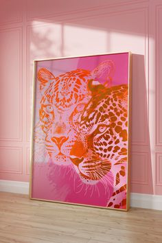 an orange and pink painting with a leopard on it's face in front of a pink wall