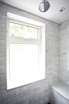 an image of a bathroom with windows by a bathtub on the left and right side