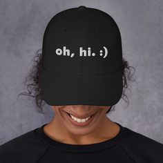 Need a trendy, modern hat for a birthday gift, Father's Day, or another fun occasion? Grab this minimalist hat from our shop, for any person and any age! ~~ THE "OH HI" DAD HAT~~ Oh, hi! A simple, silly hat that serves as a great icebreaker in public. This cap is sure to get some smiles as you rock it in public, why not pick one up? This hat Means Minimal. ~~ WELCOME TO MEANS MINIMAL. ~~ Welcome, thanks for much for visiting! Our products are here to help you embody a minimalist, flowing, and simple lifestyle. We keep your fits modern and your faces happy.  ~~ MORE DETAILS ~~ * 100% chino cotton twill * Unstructured, 6-panel, low-profile * 6 embroidered eyelets * 3 ⅛" (7.6 cm) crown * Adjustable strap with antique buckle and curved visor * Sourced from Vietnam or Bangladesh Oh Hi Modern Ha Funny Adjustable Dad Hat With Curved Bill, Funny One-size Dad Hat Baseball Cap, Funny Black Hats For Gifts, Funny Black Hats For Gift, Funny Black Hat For Gift, Funny Black Hat As Gift, Funny Dad Baseball Cap, Casual Snapback Hat For Birthday, Trendy Letter Print Hat For Gift