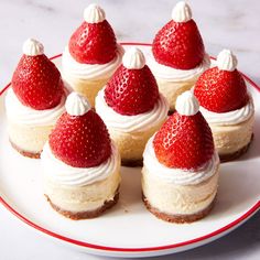 small desserts are arranged on a plate with strawberries in the top and bottom