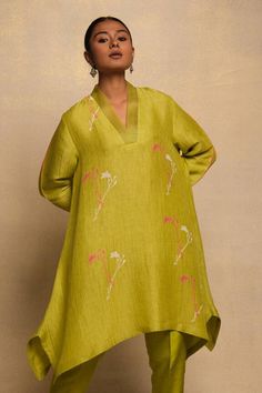 Green linen asymmetric kurta with floral motifs. Paired with a pant - Aza Fashions Summer Straight Kurta With Set-in Sleeves, Traditional Spring Kurta With Set-in Sleeves, Spring Festive Kurta With Set-in Sleeves, Designer Spring Kurta With Set-in Sleeves, Designer Wear Spring Kurta With Set-in Sleeves, Straight Kurta With Set-in Sleeves For Spring, Spring Anarkali Tunic Set, Silk Tunic With Printed Motifs For Spring, Festive Summer Sets With Asymmetrical Hem