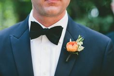 a man in a tuxedo with a boutonniere on his lapel