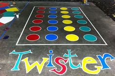 an image of a game that is painted on the ground with words twister in front of it