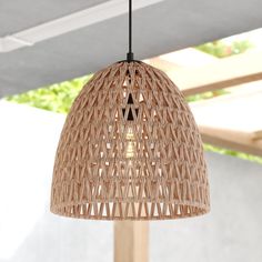 a light that is hanging from a wooden pole in a room with white walls and ceiling