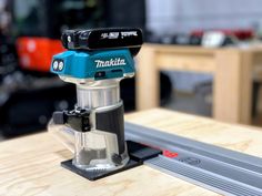 a makita router on a table in a shop