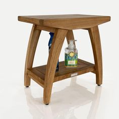 a wooden table with a bottle and soap dispenser sitting on top of it