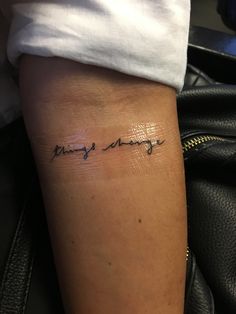 a woman with a tattoo on her arm that says, always change in cursive writing