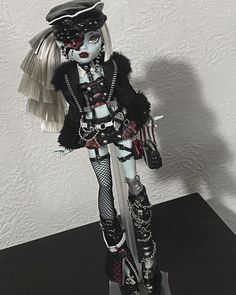 a doll is dressed in black and white