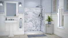 a white bathroom with blue walls and marble tile flooring, along with two sinks and a shower