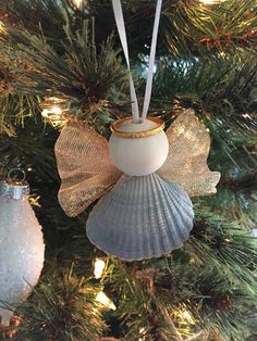 an angel ornament hanging from a christmas tree