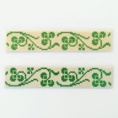 two green and white ribbons with designs on them