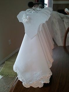 a white dress hanging on a clothes rack