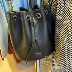 Nwot Furla Bucket Bag From Saks Fifth Avenue. Only Used Two Or Three Times, Almost Like New. There Should Be No Dents Or Scratches On This Beauty! Very Soft Subtle Leather With Drawstring Top. Comes With Original Dustbag. Hate To Let This One Go But Must Make Room For New Stuff :) This Is A Smaller To Medium Sized Bag Black Bucket Bag With Branded Hardware For Shopping, Chic Travel Bucket Bag With Branded Hardware, Elegant Bucket Bag With Top Handle And Branded Hardware, Evening Black Bucket Bag With Branded Hardware, Black Evening Bucket Bag With Branded Hardware, Evening Bucket Bags With Branded Hardware, Elegant Formal Bucket Bag With Branded Hardware, Elegant Bucket Bag With Branded Hardware, Elegant Pouch-shape Bucket Bag With Branded Hardware