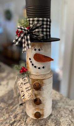 a snowman made out of tin cans on top of a counter