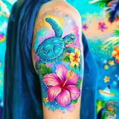 a woman's arm with a turtle and flowers painted on the back of it