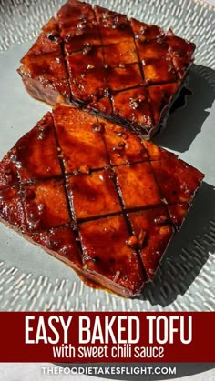 two pieces of brownies sitting on top of a metal plate with the words easy baked tofu