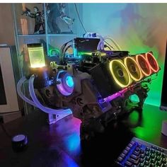 a computer and keyboard on a desk with lights