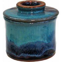 a blue and brown jar with a wooden lid