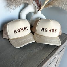 Tan HOWDY embroidered Trucker Snapback hat. This is the perfect gift for all western wear lovers.  HOWDY is embroidered in brown thread. This brand of Trucker hat is called Embroidery Plug. it's a foam front, but it is a little more structured front.  Size: One Size Fits All.  But we don't stop there - we also offer custom hat services. If you have a unique design in mind or want to make a special gift, reach out to us, and we'll bring your hat dreams to life. Country Style Baseball Cap For Western-themed Events, Country Style Baseball Cap For Western Events, Brown Trucker Hat For Western-themed Events, Brown Embroidered Baseball Cap, Embroidered Brown Cap, Adjustable Brown Hat With Embroidered Logo, Brown Adjustable Hat With Embroidered Logo, Brown Hat With Embroidered Logo, Embroidered Cream Cap