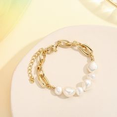 Adorn your wrist with the exquisite Baroque Pearl Bracelet, crafted from freshwater pearls of the highest quality. This timeless piece of jewelry radiates beauty and elegance, making it the perfect addition to any outfit and a must-have for your jewelry collection. DETAILS Plating: 18k Gold on Brass Materials:   18K Gold on Brass, Freshwater Pearl Measurements: Length: 6.69"(17cm) + Extender: 2.36"(6.0cm) Weight:  15.05g Note: It will be in stock in 7 business days! Gold Pearl Bracelet With Pearl Chain, Trendy Pearl Bracelet With Pearl Charm, Trendy Pearl Bracelet With Pearl Chain, Trendy Pearl Bracelets With Pearl Chain, Trendy Pearl Chain Bracelet For Gift, Trendy Pearl Bracelet For Gift, Trendy Pearl Bracelet For Gifts, Trendy Gold Pearl Bracelet, Trendy White Pearl Chain Bracelet