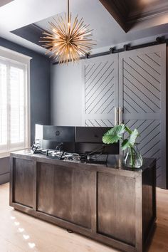 a room with a large wooden cabinet and a potted plant on top of it