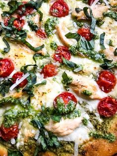 a pizza with tomatoes, spinach and cheese on it's crust is shown