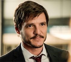 a man wearing a suit and tie in an office