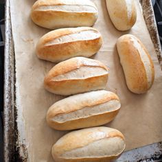 several loaves of bread sitting on top of a baking sheet