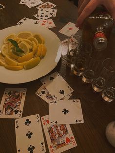 playing cards and lemon slices on a table