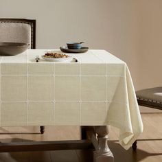 a dining room table with a bowl of cereal on it and an empty plate sitting on top of the table