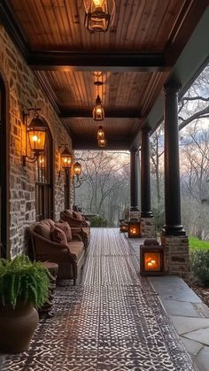 an outdoor covered porch with seating and lights