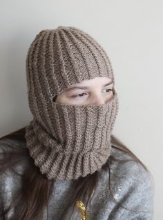 Embrace the winter chill with our exquisite handmade, knitted unisex balaclava, thoughtfully crafted from lightweight and warm alpaca wool yarn. Designed to fit both teens and adults comfortably, this balaclava is the epitome of style and functionality. Its luxurious texture, delicately adorned with a mesmerizing cable pattern, adds a touch of elegance to your winter wardrobe. Indulge in the unparalleled softness and insulating properties of alpaca wool, keeping you cozy and snug during the coldest of days. Despite its incredible warmth, the lightweight nature of the balaclava ensures breathability, preventing you from feeling stuffy or uncomfortable. Whether you're conquering snowy peaks, taking a serene winter walk, or simply relishing the crisp air, our balaclava promises to be your tru Casual Knitted Balaclava One Size, Casual Knit Balaclava One Size, Casual Knitted One-size Balaclava, Casual One-size Knit Balaclava, Handmade Winter Knitting Pattern One Size, Hand Knitted Brown Winter Knitting Pattern, Handmade Yarn Knitting Pattern For Winter, Handmade Winter Knitting Pattern In Yarn, Cozy Knitting Pattern One Size Fits Most