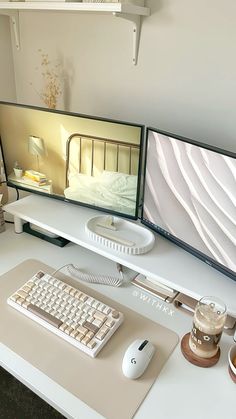 two computer monitors sitting on top of a white desk