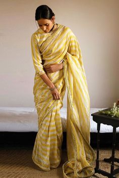 Yellow and white saree made in handloom tissue base with all over stripe pattern and zari lace trimmings.
Components: 1
Pattern: Woven
Type Of Work: Stripe, Zari Trimmings
Fabric: Handloom Tissue
Color: Yellow,White
Other Details: 
Weight (in kg): 1
Note: Stitched blouse and choker worn by the model is not for sale
Disclaimer: The fabric, color and texture of the final garment might have slight variations from the studio images and we use only handwoven fabrics
Occasion: Reception,Sangeet - Aza Yellow And White Saree, Studio Images, Saree For Women, White Saree, Handwoven Fabric, Fashion App, Sarees Online, Aza Fashion, Clothing Patterns