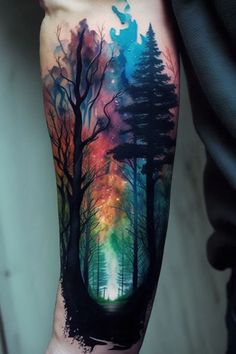 a man's arm with trees and stars in the sky tattoo on his forearm