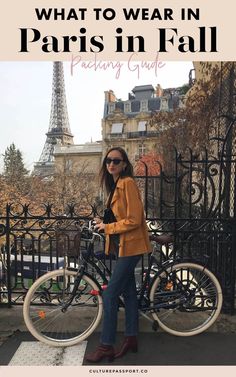 a woman standing next to her bike with the eiffel tower in the background