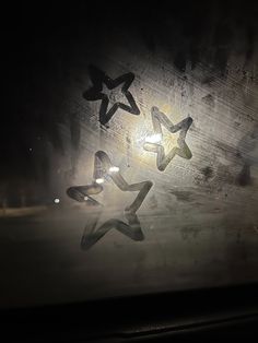 three stars are seen through the window of a vehicle