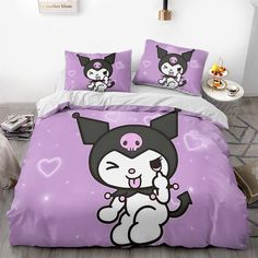 a bed with two pillows on top of it and an image of a cat in the middle