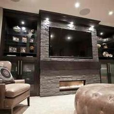 a living room with a couch, chair and television on the wall in front of it