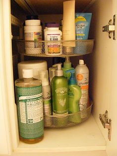 the inside of a refrigerator with two shelves filled with different types of cleaning products and personal care items