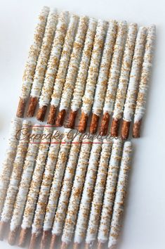 several white and brown candy sticks with sprinkles on them sitting next to each other