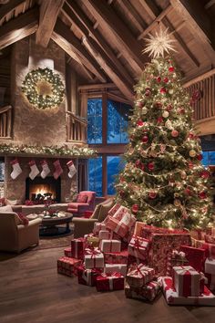 a christmas tree with presents under it in a living room next to a fire place