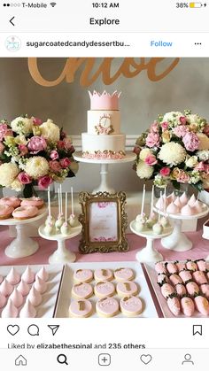 a table topped with lots of pink and white desserts