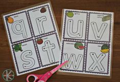 two printable alphabet worksheets with scissors on a table