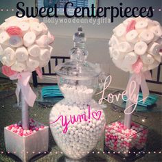 two vases filled with buttons and flowers on top of a table