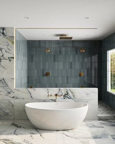 a large white bath tub sitting next to a window