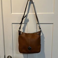 Excellent Used Condition Brown Dooney And Bourke Cross Body Bag With Adjustable Strap. Exterior Is In Excellent Shape. Interior Has Some Pen Marks. Please See All Pictures. Classic Brown Bag With Pebbled Texture, Brown Leather Shoulder Bag With Pebbled Texture, Tan Pebbled Leather Shoulder Bag For Everyday Use, Tan Pebbled Leather Bag For Everyday Use, Tan Textured Leather Bag For Errands, Everyday Tan Pebbled Leather Bag, Everyday Use Crossbody Bag With Pebbled Texture, Pebbled Texture Crossbody Bag For Everyday Use, Brown Pebbled Texture Shoulder Bag For Daily Use