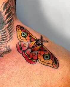 a man with a butterfly tattoo on his chest