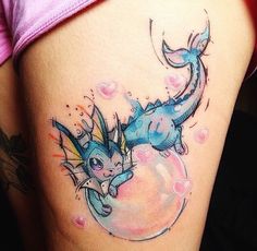 a woman's thigh with an image of a pokemon tattoo on the side of her leg